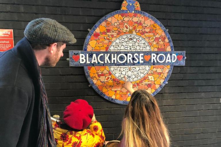A family looking at the new Blackhorse Road station roundel